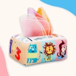 La Boîte à Mouchoirs Magique est un jouet en tissu doux avec des animaux colorés et des chiffres, avec des mouchoirs roses, orange et jaunes pour un plaisir ludique sans fin.
